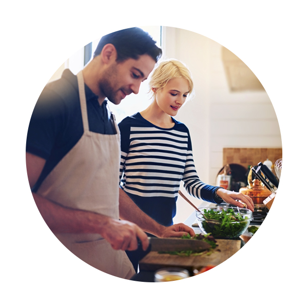 Couple doing cooking prep work in kitchen